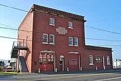 Photograph of a three-story brick building with an inset sign reading "Fire Station No. 2"