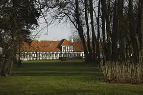 Half-timbered brick building with tiled roof