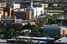 photo of the campus of Arizona State University, taken from a high angle from the top of Tempe Butte, looking down on the campus nestled among the city buildings