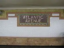 Tilework in original station, which includes a mosaic tile sign saying "Atlantic Avenue"