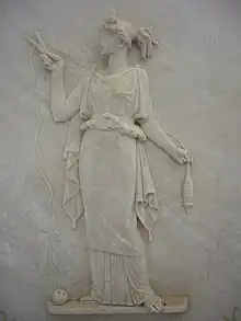 Atropos cutting the thread of life. Ancient Greek low relief