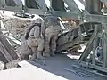 Soldiers (299 MRBC USAR ) attach the link reinforcement set to the underside of the bottom panel