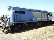 Diesel locomotive 1604 sits on a track, painted in the blue and white QR livery.