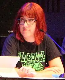 Cropped image of Watson on a convention panel