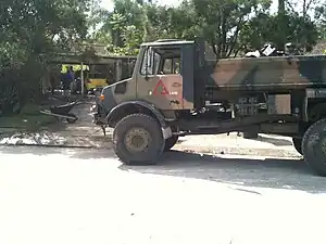 Photograph of a large truck in front of a house