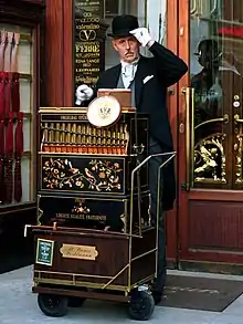 A street organ (locally called Werklmann) player with his paper roll-driven Berlin-style barrel organ in Vienna.