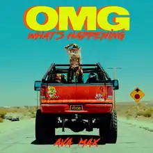 Max is seen standing on top of a red monster truck while wearing a red cowboy hat. The song title is displayed above, with the artist name shown underneath.