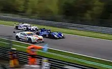 Three cars on a track