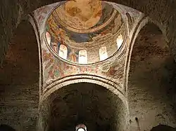 Photograph of a church dome covered with frescoes. From inside the building.