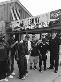 A black-and-white photo of Steve Azar and The King's Men, standing in front of a sign reading "Club Ebony" and "Coca-Cola".