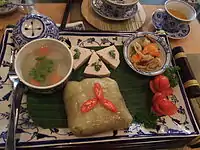 Bánh chưng is served with chả lụa and other dishes