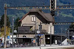 Three-story stone building with gabled roof