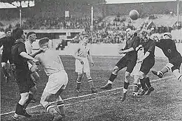 Aerial play with two Belgian players and the Luxembourg keeper trying to touch the ball