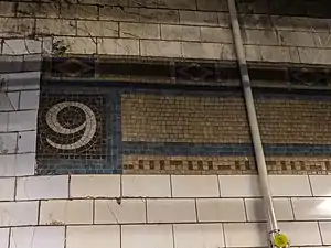 Original mosaic trim remnant in the southbound fare area