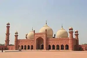 Front view of a Mughal-style mosque in red stone