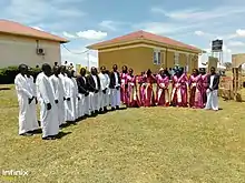 Baganda people in their cultural outfits. Men put on Kanzu, and ladies Ggomeesi in Uganda.