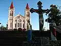 The cathedral from the stairs with the large Calvary at the terminus of the stone stairs.