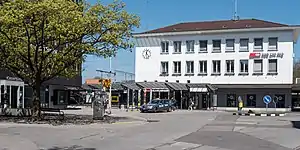 Wide three-story building with hip roof