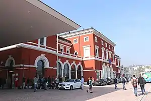 Three-story building with hip roof and two-story wings