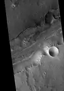 Bahram Vallis, as seen by HiRISE.  Rotational landslides (slumps) are visible at the base of north wall.