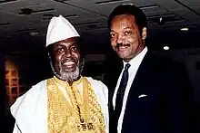 Balozi standing with the African-American activist and politician, Jesse Jackson