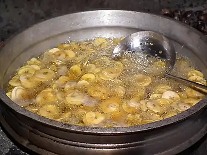 Banana chips being prepared by deep frying