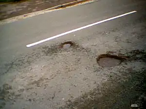 Local newspapers reported on the weather-induced potholes during the second week of January 2010. This one is on Bretch Hill, near Dover Avenue. They were filled in by May 2010.