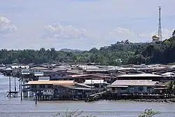 Stilt houses in Mukim Tamoi, with Istana Nurul Iman in the background