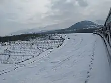 Train rounding a snowy curve