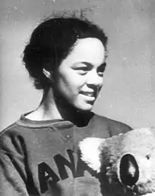 Photo of Barbara Howard looking to the side and holding a stuffed koala bear