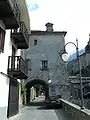 A tower house crosses a road.