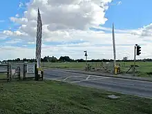 Frequent temporary closing of the barriers was required for larger aircraft movements prior to a new road being built that avoids this.