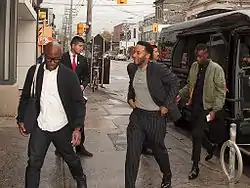 Jenkins, Holland and Sanders exiting a limousine van