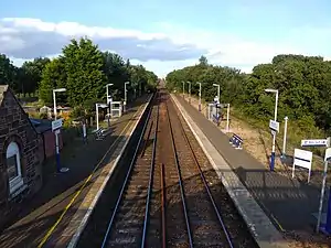 A picture depicting the two platforms of Barry Links from the footbridge over the level crossing