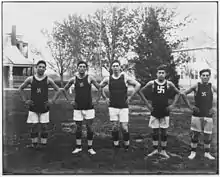 five young men in basketball uniforms with swastika logo