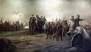 Soldiers and cannon on the battlefield; an officer on a white horse points to direct his men.