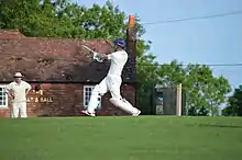 Batsman hits out in front of the Bat & Ball public house