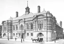 Black and white photo of a two-story stone and brick building