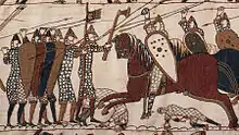A scene from the Bayeux Tapestry depicting mounted knights attacking footsoldiers