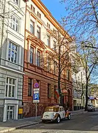 View from the street, with the ancient limousine parked at the front