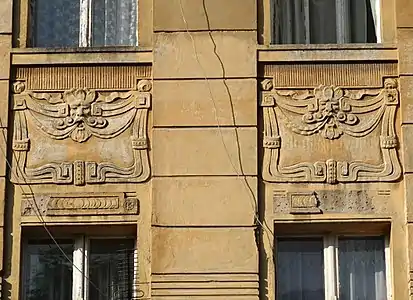 Mask motif in cartouches
