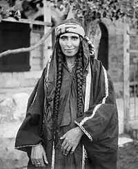 Image 12A Bedouin woman in Jerusalem, sometime between 1898 and 1914, dressed in Palestinian costume, the traditional clothing worn by Palestinians. Many of the handcrafted garments were richly embroidered and the creation and maintenance of these items played a significant role in the lives of the region's women. Until the 1940s, traditional Palestinian costumes reflected a woman's economic status, whether married or single, and the town or district of origin, and a knowledgeable observer could glean such information from the fabric, colors, cut, and embroidery motifs (or lack thereof) in a given woman's apparel.