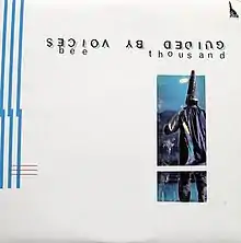 Against a blank white background, the band name appears upside-down in a distressed font. The album title appears orientated normally. Below the text is a relatively small collaged image of a wizard wearing a purple hat and cape facing a dark silhouette of a house.