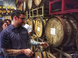 Image 15A beer sommelier tapping a barrel for a taste at Nebraska Brewing Company (from Craft beer)