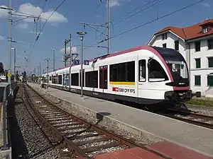 White-and-black train at island platform