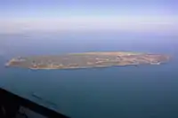 The island seen from the southeast out of an airplane window. The cliffs, the ferry dock and the various settlements and lakes are clearly visible