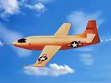 An orange plane soars through the sky.