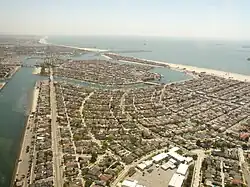 Naples Island is in the middle distance in this photo, with Belmont Park in the foreground, Belmont Shore to the right, and The Peninsula and the neighboring city of Seal Beach beyond, looking southeast.