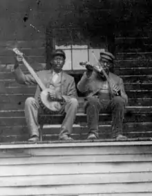 Lew and Ben Snowden on banjo and fiddle at their home in Clinton, Knox County, Ohio, c. 1890s