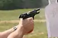Beretta M9 semi-automatic pistol exhibiting muzzle rise just after firing a 9×19mm Parabellum cartridge.